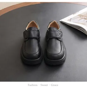 Classic black boys' British style school shoes featuring durable hook-and-loop straps