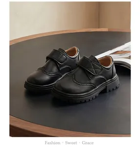 Detailed view of boys' black Brogue leather shoes featuring soft soles and velcro straps