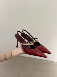 Side view close-up of elegant red pointed-toe slingback high heels with a cream strap