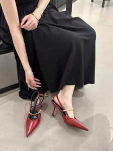 Elegant red pointed-toe slingback high heels with a chic gold metal buckle bar.