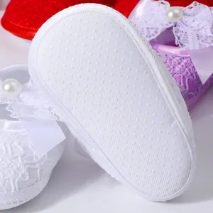 Soft sole newborn walking shoes for baby girls featuring delicate lace bow and pearl