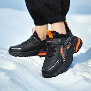 Boys waterproof leather winter sneakers with warm fur lining in snowy background