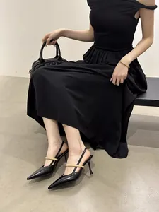 Black pointed-toe slingback heels with gold metallic strap for elegant office wear
