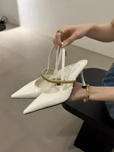 Elegant white pointed-toe high heels featuring a stylish gold metallic strap and slim heel.