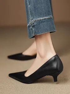 Side detail of elegant black pointed-toe kitten heel pumps for professional commute