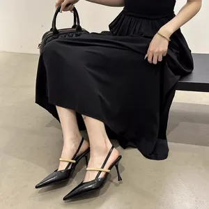 Elegant black pointed-toe slingback heels with gold metal strap for women's fashion