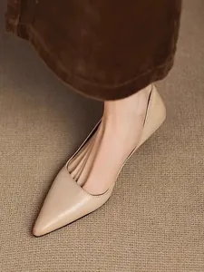 Close-up of elegant nude pointed-toe pumps with chic side cutout for a refined look