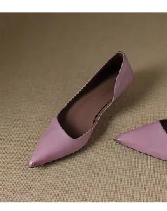 Elegant purple pointed-toe pumps with mid-heel, showing soft leather texture and fine stitching