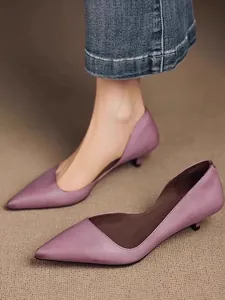 Detailed view of elegant purple pointed-toe kitten heel pumps with side hollow design