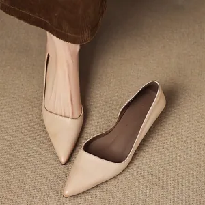 Elegant nude French pointed-toe pumps featuring a mid-heel and side cutout design