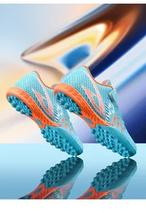 Visuale dettagliata delle scarpe da calcio TF per bambini con suole antiscivolo arancioni