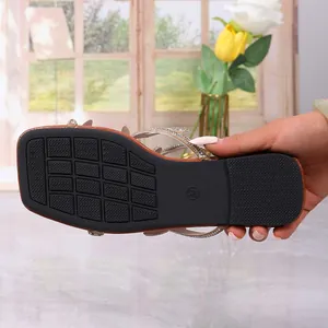 Macro detail showing the anti-slip rubber outsole of women square toe rhinestone sandals.