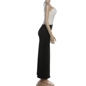 Profilo laterale di un abito aderente bicolore bianco e nero con scollo halter chic