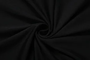 Vista macro del tessuto a maglia nero di alta qualità con texture morbida e trama fine