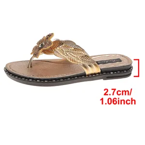 Close-up detail of golden women flip-flops showing the 2.7cm platform heel height