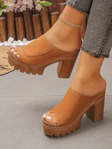 Chic brown peep-toe platform mules featuring sturdy block heels and white contrast stitching.