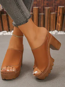 Close-up view of stylish brown platform chunky heel mules with decorative white stitching
