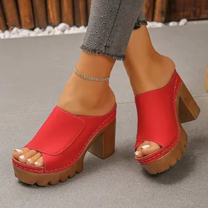 Close-up detail of vibrant red open-toe platform sandals with a chunky high block heel