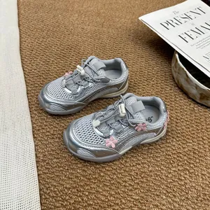 Trendy silver mesh sneakers for girls featuring pink floral accents and soft flexible soles.