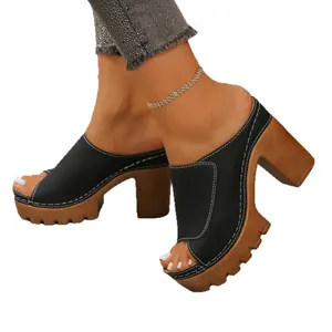 Stylish black peep-toe platform mules with chunky brown heels and white stitching detail