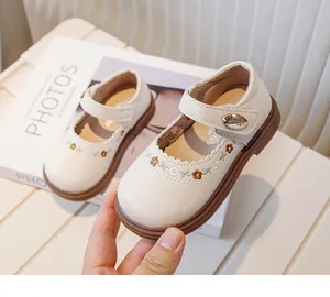 Close-up of white baby girl Mary Janes with floral embroidery and soft sole