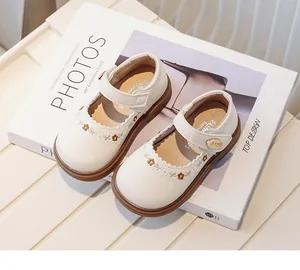 Detail view of white girls Mary Jane shoes with delicate floral embroidery and soft soles