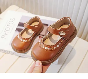 Detailed view of brown girls' Mary Jane shoes featuring floral embroidery and soft soles