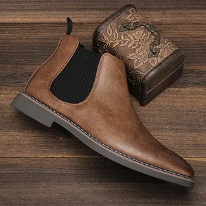 Detail view of brown men's Chelsea boot with distressed finish and elastic gore