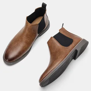 Detailed macro view of stylish brown men's Chelsea boots with elegant wipe-color finish