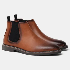 Detail of brown Chelsea boots for men featuring a polished finish and elastic side panels