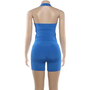 Detailed back view of a blue two-piece sporty halter neck tank top and tight shorts set for women