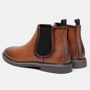 Rear view of brown Chelsea boots showing leather texture and elastic side panels