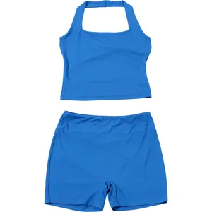 Front view of a blue halter neck crop top and matching athletic tight shorts set