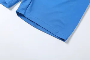 Close-up macro detail of blue athletic fabric showing double-needle hem stitching.