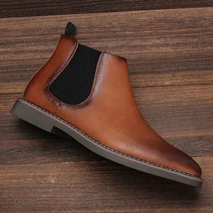 Close-up detail of a men's brown burnished Chelsea boot with elastic side panel.