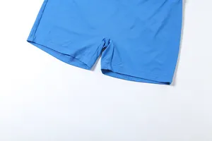 Close-up of women's blue sports tight shorts showing fabric texture and hem detail.
