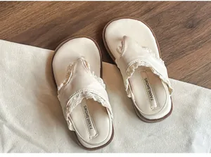 Vue détaillée des sandales en dentelle crème pour enfants avec semelle souple pour l'été