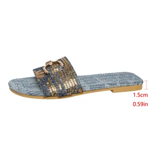 Detailed side view of denim slippers with gold sequins and 1.5cm flat heel height