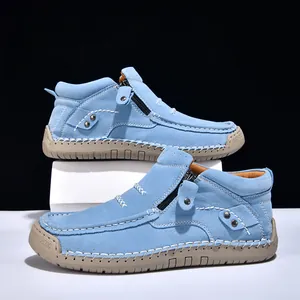 Detailed view of light blue suede high-top loafers with hand-stitched detailing.