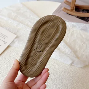 Detailed view of brown wavy anti-slip sole for girls' summer Roman sandals, size 23.