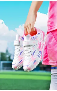 Close-up of pink and purple patterned soccer training shoes for children with TF cleats
