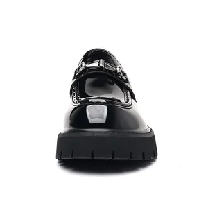 Front view detail of black patent leather loafers with thick lug sole and bit buckle