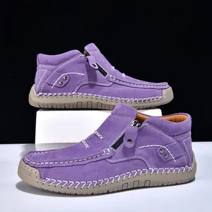 Detail view of purple suede high-top slip-on shoes with white stitching and side zipper