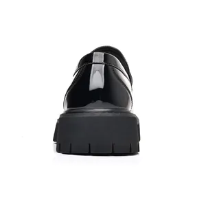 Rear view of men's black patent leather platform loafers with chunky lugged rubber sole