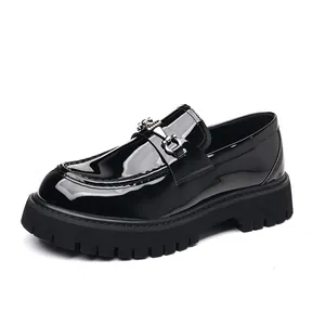 Detailed view of men's black patent leather loafer with chunky lug sole and metal buckle