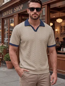 Detail view of men's beige jacquard polo shirt with navy contrast collar and cuffs.