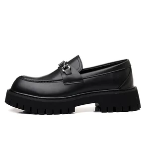 Close-up of black leather platform loafer with silver buckle and chunky lug sole