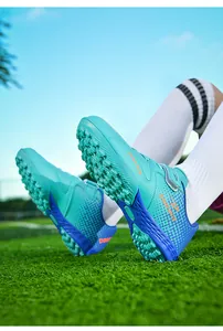 Detailed view of children's turf soccer cleats with anti-slip studs and velcro strap