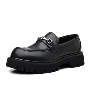 Close-up of black leather loafer with thick platform sole and silver bit detail