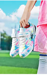 Colorful kids' turf soccer shoes featuring a vibrant graphic pattern and Deerway logo.